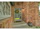 Inviting front entryway with a brick facade and decorative wreath on the door at 10356 Lions Heart, Lone Tree, CO 80124