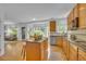 Open kitchen with island, stainless steel appliances and breakfast bar overlooking living areas at 10356 Lions Heart, Lone Tree, CO 80124
