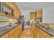 Well-equipped kitchen with black countertops, wooden cabinets, and modern appliances at 10356 Lions Heart, Lone Tree, CO 80124