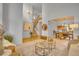 Open-concept living space with staircase, dining area and seating, creating an airy and inviting atmosphere at 10356 Lions Heart, Lone Tree, CO 80124