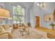 Elegant living room with soaring ceilings and a large window, offering plenty of natural light at 10356 Lions Heart, Lone Tree, CO 80124