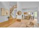 Open-concept living space with staircase, dining area and seating, creating an airy and inviting atmosphere at 10356 Lions Heart, Lone Tree, CO 80124