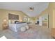Bright main bedroom with vaulted ceiling, plush accents and an inviting fireplace seating area at 10356 Lions Heart, Lone Tree, CO 80124
