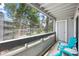 Enjoy the views of the mature trees from the screened-in balcony with blue Adirondack chairs at 14435 E 1St Dr # B2, Aurora, CO 80011