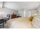 Bright bedroom with desk, mid-century modern dresser, and large bed at 14435 E 1St Dr # B2, Aurora, CO 80011
