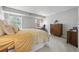 Bright bedroom with large windows, light gray walls, and mid-century modern furniture at 14435 E 1St Dr # B2, Aurora, CO 80011