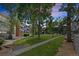 Exterior view of beautiful condo community boasts lush lawns, mature trees, and easy walking access at 14435 E 1St Dr # B2, Aurora, CO 80011