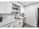 Modern kitchen features white cabinets, stainless steel appliances, and granite countertops at 14435 E 1St Dr # B2, Aurora, CO 80011