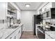 Updated kitchen features white cabinets, granite countertops, and stainless steel appliances at 14435 E 1St Dr # B2, Aurora, CO 80011