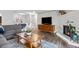Open-concept living room featuring fireplace, mounted TV, and comfortable seating at 14435 E 1St Dr # B2, Aurora, CO 80011