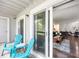 Relax in the outdoor space with bright blue Adirondack chairs and a sliding door into the cozy living room at 14435 E 1St Dr # B2, Aurora, CO 80011