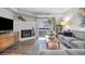 Bright living room with fireplace, hardwood floors, and a slider to the balcony at 14435 E 1St Dr # B2, Aurora, CO 80011