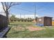 Secluded backyard with a small shed, brick patio area, privacy fence, and mature landscaping at 10505 Clarkson St, Northglenn, CO 80233