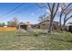 Spacious backyard featuring a shed, wooden fence, mature trees, and plenty of room for outdoor activities at 10505 Clarkson St, Northglenn, CO 80233