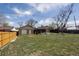 Large backyard with a detached garage, storage shed, and mature trees providing shade and privacy at 10505 Clarkson St, Northglenn, CO 80233