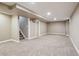 Unfinished basement with neutral carpet, white trim, and staircase access at 10505 Clarkson St, Northglenn, CO 80233