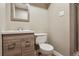 Modern bathroom with a wood vanity, stylish mirror, and a glass-enclosed shower for a spa-like experience at 10505 Clarkson St, Northglenn, CO 80233