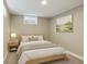 Well-lit bedroom with soft decor, a cozy bed, side table, and a decorative picture frame for a relaxing ambiance at 10505 Clarkson St, Northglenn, CO 80233