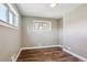 Empty bedroom with hardwood floors, fresh paint, and natural light at 10505 Clarkson St, Northglenn, CO 80233