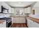 Modern kitchen featuring white cabinets, butcher block countertops, and stainless steel appliances at 10505 Clarkson St, Northglenn, CO 80233