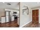 Open-concept kitchen with white cabinets, stainless steel appliances, and hardwood flooring at 10505 Clarkson St, Northglenn, CO 80233