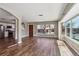 Open living area with hardwood floors and natural light from large windows, adjacent to the kitchen at 10505 Clarkson St, Northglenn, CO 80233