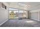 Light-filled sunroom with sliding glass doors and carpet flooring at 10505 Clarkson St, Northglenn, CO 80233
