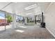 Spacious sunroom with large windows, a wood-burning stove, and carpeted floors at 10505 Clarkson St, Northglenn, CO 80233