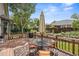 Outdoor living on the wood deck with an umbrella-covered dining table and grill, plus bench seating at 10553 Stonemeadow Dr, Parker, CO 80134