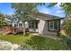 Landscaped backyard with a deck, lush green lawn, and mature trees at 10553 Stonemeadow Dr, Parker, CO 80134