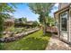 Serene backyard featuring well-maintained landscaping, a deck, and artificial turf at 10553 Stonemeadow Dr, Parker, CO 80134
