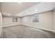 Large, carpeted basement space with natural light from two windows at 10553 Stonemeadow Dr, Parker, CO 80134