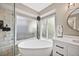 Bathroom with a soaking tub and a large frosted window, providing lots of light and privacy at 10553 Stonemeadow Dr, Parker, CO 80134