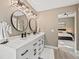 Main bathroom featuring dual sinks, black hardware, round mirrors, and modern fixtures at 10553 Stonemeadow Dr, Parker, CO 80134