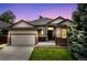 Charming single-Gathering home showcasing a well-maintained lawn, two-car garage, and inviting front entrance at 10553 Stonemeadow Dr, Parker, CO 80134