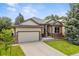 Landscaped single-Gathering home featuring a well-manicured lawn, two-car garage, and inviting entrance at 10553 Stonemeadow Dr, Parker, CO 80134