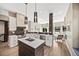 Bright, modern kitchen with an island, stainless steel appliances, and seamless transition to the living room at 10553 Stonemeadow Dr, Parker, CO 80134