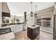 Modern kitchen featuring white cabinets, an island, stainless steel appliances, and stylish pendant lighting at 10553 Stonemeadow Dr, Parker, CO 80134