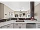 Open-concept kitchen featuring stainless steel sink, modern cabinets, and seamless flow to the living room at 10553 Stonemeadow Dr, Parker, CO 80134