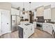 Stylish kitchen with stainless steel appliances, white cabinets, an island, and modern pendant lights at 10553 Stonemeadow Dr, Parker, CO 80134