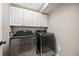Well-equipped laundry room featuring modern appliances and ample storage space at 10553 Stonemeadow Dr, Parker, CO 80134