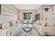 Open-concept living room with stylish decor, bright windows, and comfortable seating arrangement at 10553 Stonemeadow Dr, Parker, CO 80134