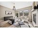 Bright and airy living room featuring modern furnishings, a fireplace, and large windows with backyard views at 10553 Stonemeadow Dr, Parker, CO 80134