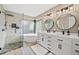 Beautiful main bathroom with dual sinks, freestanding tub, and walk-in shower with tile surround at 10553 Stonemeadow Dr, Parker, CO 80134