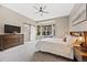Spacious main bedroom with a bay window, barn door to bath, and a ceiling fan at 10553 Stonemeadow Dr, Parker, CO 80134
