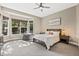 Main bedroom with bay windows providing natural light, carpeted floors, and neutral paint at 10553 Stonemeadow Dr, Parker, CO 80134
