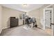 Home office with a dark colored desk, cabinets and carpeted floors at 10553 Stonemeadow Dr, Parker, CO 80134