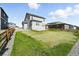 A well-maintained backyard features a concrete patio, green lawn, and wood fence at 226 Racer St, Bennett, CO 80102