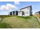 A lovely backyard has a spacious lawn, concrete patio, and wood fence at 226 Racer St, Bennett, CO 80102