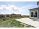 Landscaped backyard with spacious patio, lush grass, and wood fence at 226 Racer St, Bennett, CO 80102